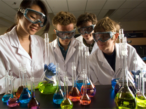 Students in the lab with beakers of coloured liquids