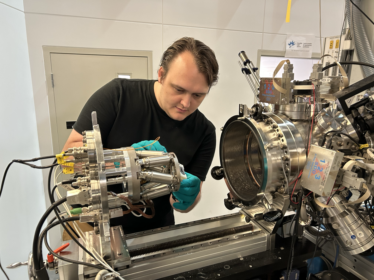 Graduate Student working on loading a sample to a analysis chamber of the Spherical Grating Monochromator Beamline