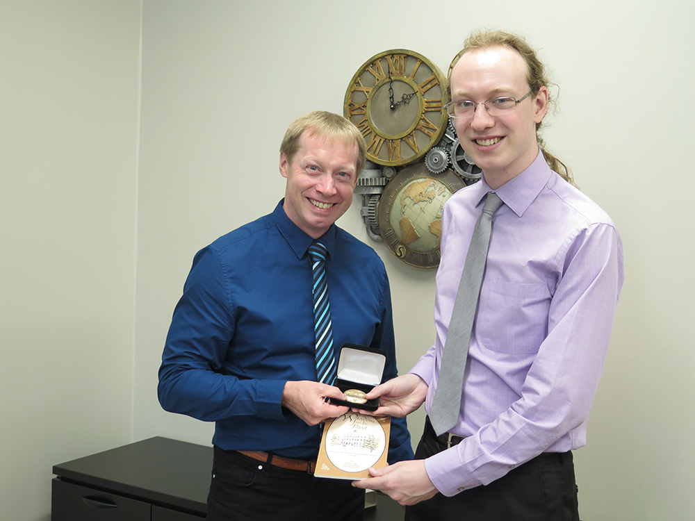 Dr. Paul Garrett, presenting JB Reynolds Medal to Devin Hymers