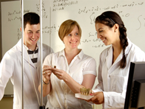 students and instructor working on experiment
