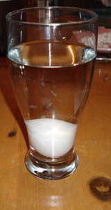 egg in glass of water, settled to the bottom